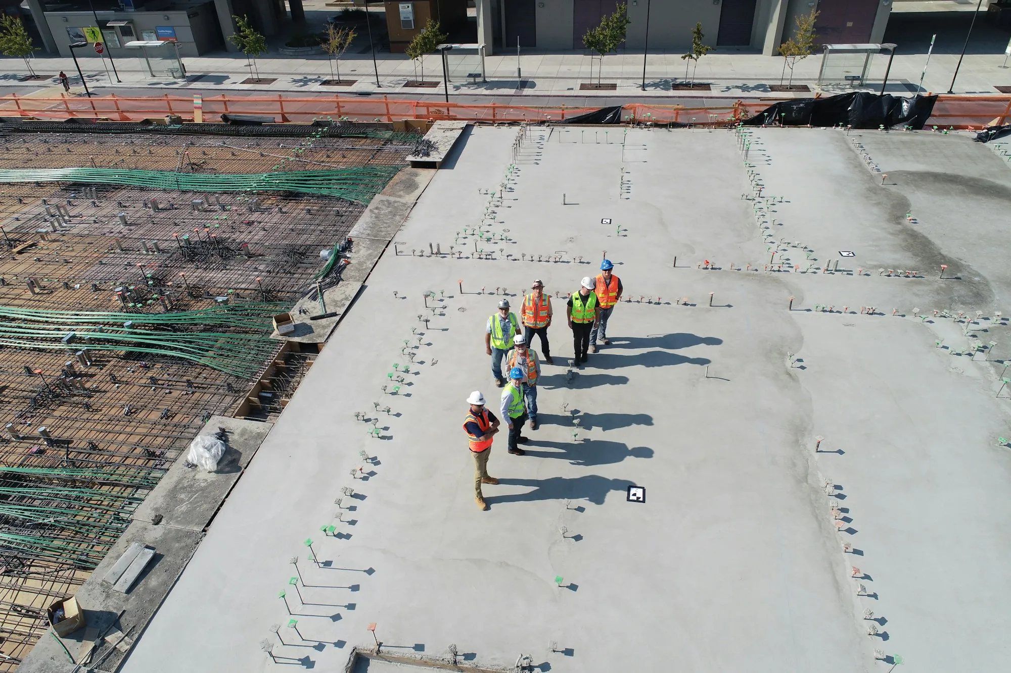 Crew walking across a large finished concrete slab